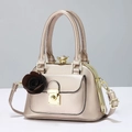 Close-up of champagne gold shell bag with crystal clasp and 3D rose ornament detail - Champagne