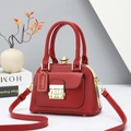 Close-up of red crossbody bag with textured cross-grain leather and golden hardware details - Red