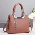 Elegant mauve pink crossbody handbag with lychee texture and silver clover charm - Pink