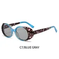 Oval tortoiseshell sunglasses in blue with grey lenses and white floral side detail - Blue Tortoise Frame Transparent Gray Lens