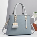 Detail view of macaron blue tote bag showing woven texture and gold metal buckle - 30x12.5x23cm / Blue