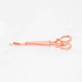 Macro detail of rose gold scissor shaped hair clip with polished metallic finish - Rose Gold Scissors