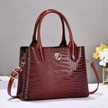 Deep red crocodile embossed leather handbag with gold metal logo and shoulder strap - Wine Red