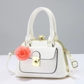 Close-up of white PU leather pillow bag with pink fabric rose and gold-tone hardware - White