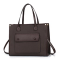 Detail view of brown textured tote bag with woven fabric panel and stylish front pocket - Coffee
