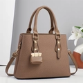 Vintage woven shoulder bag in dark khaki with top handle and matching mini charm - Brown