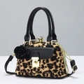 Detailed view of leopard print handbag with gold hardware and 3D floral charm detail - Yellow Leopard