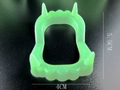 Detailed view of green glowing vampire teeth toy showing dimensions 5.5cm by 4cm - Luminous Green