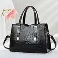 Elegant black faux crocodile leather handbag with silver hardware and shoulder strap - Black