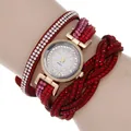 Close-up of red multi-layer wrap watch with sparkling crystals and golden quartz dial - Red