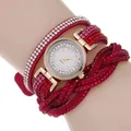 Macro detail of red rhinestone wrap watch strap with gold casing and crystal bezel - Rose Red