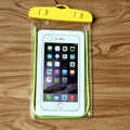 Universal clear PVC waterproof phone pouch with yellow swivel locks on wood surface - Noctilucent Yellow