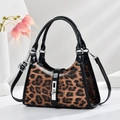 Detail of leopard print handbag featuring black patent leather trim and silver metal buckle - One Size(26x9x18cm) / Earthy Yellow