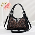 Detail of glossy leopard print crescent bag with black leather trim and silver hardware - One Size(26x9x18cm) / Coffee