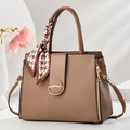 Vintage brown textured tote bag with gold buckle and houndstooth scarf on white background - Dark Khaki