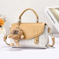 Detailed macro view of beige and khaki crossbody bag with diamond lattice texture - Apricot and White