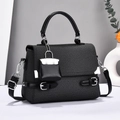 Fashionable black woven texture handbag with silver hardware and small hanging charm - Black