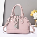 Pink lychee texture shell handbag with heart pendant and silver tassel detail - Pink