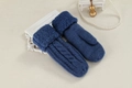 Detailed view of blue cable knit mittens with plush faux fur cuffs on beige background - One Size / Blue