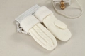 Warm white knitted mittens with plush cuffs displayed on an elegant decorative tabletop - One Size / White
