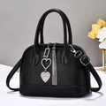 Elegant black Boston handbag with lychee texture leather, silver tassels and heart charm - Black