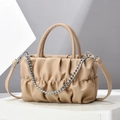 Elegant beige pleated crossbody bag with chain and leather strap on a minimalist plinth - Khaki