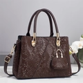 Detail of dark brown faux snake skin texture and gold hardware on tote bag - L28 W13 H20 / Coffee