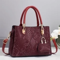 Detailed close-up of wine red snakeskin texture handbag with gold metal hardware and purse - L28 W13 H20 / Red