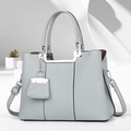 Detailed texture of light grey-blue lychee grain leather with silver U-shaped metal decor - Blue
