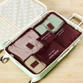 Deep wine red 6-piece waterproof travel organizer set packed in a suitcase - Burgundy