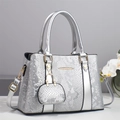 Detail of silver snakeskin textured tote bag with detachable mini pouch and gold hardware - Silver