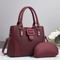 Elegant burgundy handbag set with textured panels and golden hardware accessories - Red