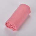 Pink linen-style cotton blend scarf rolled up on white background for travel sun protection - 32# Leather Red