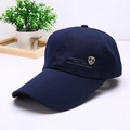 Detail of dark blue baseball cap featuring intricate gold shield logo embroidery - Navy Blue