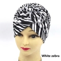 Detail view of white zebra print turban hat with unique twisted knot design for stylish look - One Size / White Zebra Pattern