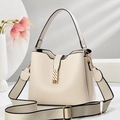 Detail of lychee textured cream bucket bag with wide woven strap and gold metal buckle - Off-white