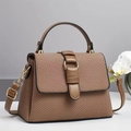 Brown woven texture handbag with leather straps and gold ring buckle in a minimalist setting - Apricot