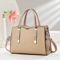 Elegant khaki woven crossbody bag with leather handles and adjustable strap in trapezoid shape - Light Khaki