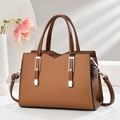 Detail view of brown crossbody bag with twill texture, silver hardware and strap - Earthy Yellow