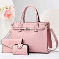 Detailed view of pink crocodile textured bag set including tote with metal buckle and pouches - Pink