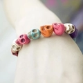 Multicolor synthetic turquoise skull bead bracelet worn on wrist for trendy style - Multicolor