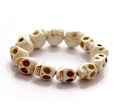 Close-up of skull beaded bracelet with off-white synthetic stone and antique cracked texture - White