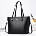Elegant black minimalist faux leather tote bag with gold hardware and shoulder strap - Black