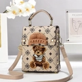 Detailed close-up of a beige crossbody bag featuring teddy bear patch and metal rivets - Khaki