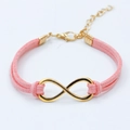 Pink suede cord bracelet featuring a golden infinity symbol and adjustable clasp - Infinity Suede Cord Style / Pink