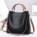 Minimalist black lychee leather tote bag with brown handles and adjustable shoulder strap - Black