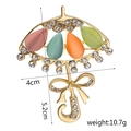 Detail view of a gold umbrella brooch with colorful cat eye stones and dimensions - C1041 Colorful Umbrella