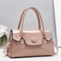 Elegant light pink patent leather handbag with gold metal clasp and minimalist floral background - Khaki