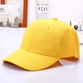 Close-up of bright yellow cotton baseball cap with six-panel structure and curved brim - Yellow