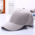 Side view of light grey cotton baseball cap with six-panel design and curved brim - Gray